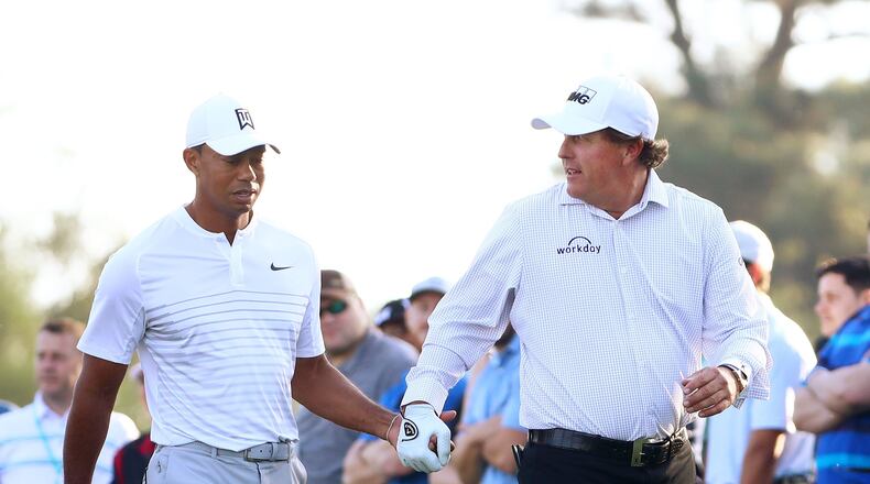 Tiger Woods and Phil Mickelson walk off the 10th tee box during a practice round for the Masters in April 2018.