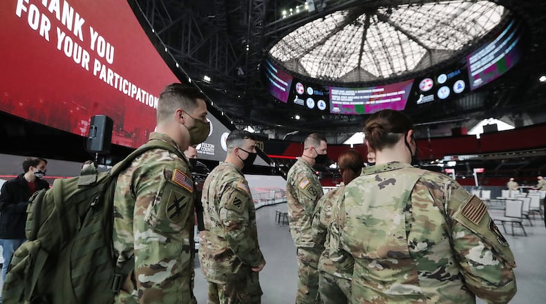 032321 Atlanta: Some of the 222 U.S. Army troops gear up at Mercedes-Benz Stadium as operations get under way for the facility to become the largest Community Vaccination Center in the southeast serving an average of 42,000 citizens a week on Tuesday, March 23, 2021, in Atlanta. There are 202 soldiers from Fort Stewart and twenty U.S. Army medical specialists that will operate some of the vaccination areas located inside Mercedes-Benz Stadium. “Curtis Compton / Curtis.Compton@ajc.com”