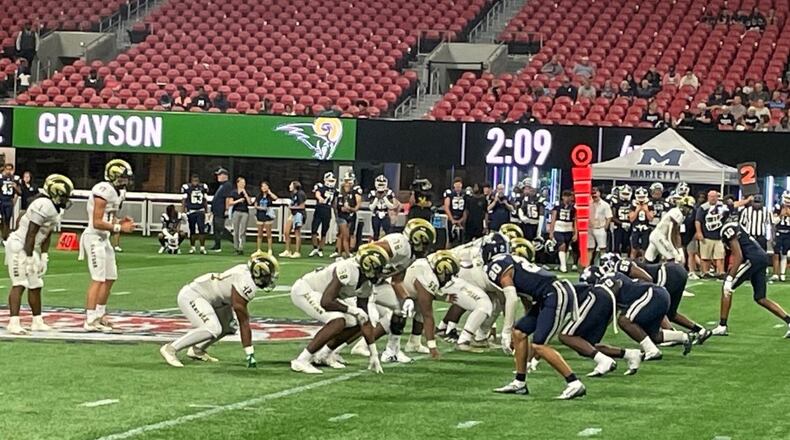 The Grayson Rams offense runs out the clock in the final minutes of a 32-12 victory over Marietta at Mercedes-Benz Stadium in the Corky Kell Classic on Aug. 20, 2022.