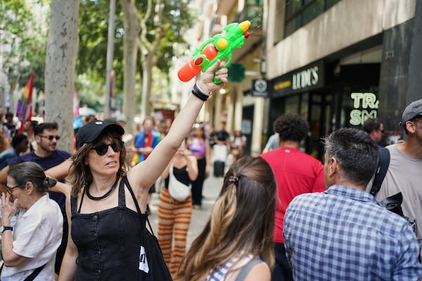 A protester with a water gun takes part in a protest against overtourism in Barcelona, Spain, Sunday, June 15, 2025. (AP Photo/Pau Venteo)
