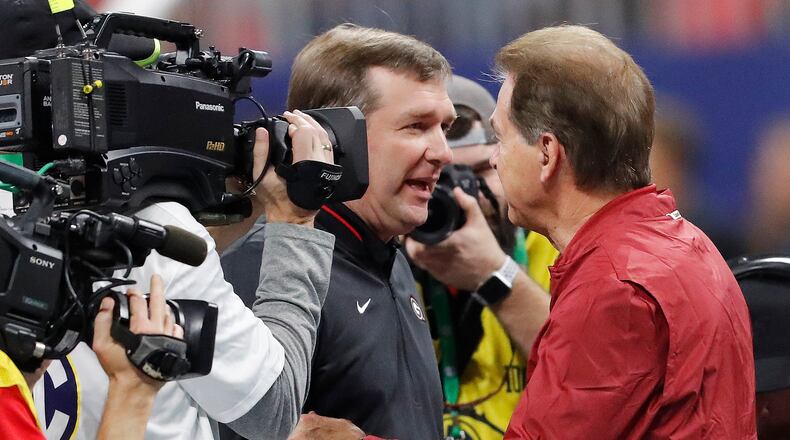 Georgia head coach Kirby Smart, left, speaks with Alabama head coach Nick Saban before the 2018 Southeastern Conference championship at Mercedes-Benz Stadium on Saturday, Dec. 1, 2018, in Atlanta. (AP Photo/John Bazemore)