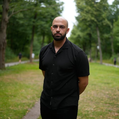 Police officer Ali Darwich poses for a portrait near the scene where a car rammed into a crowd at the Pride March in Berlin, Germany, Sunday, July 26, 2026. (AP Photo/Markus Schreiber)