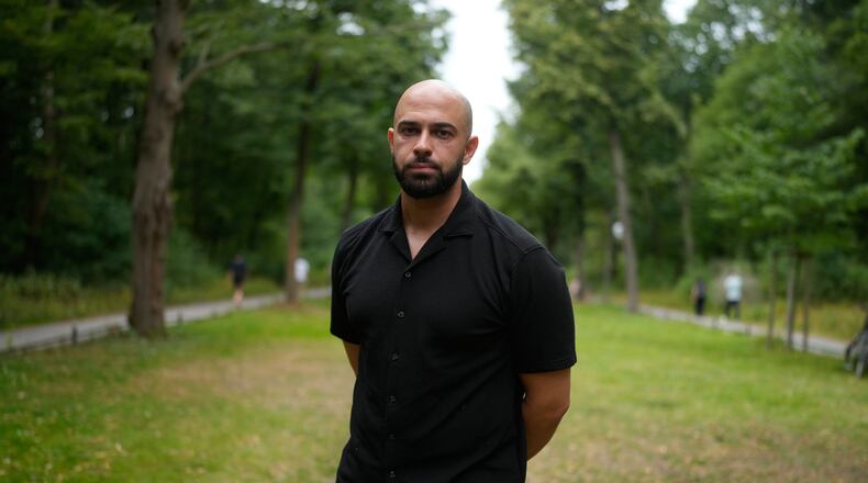 Police officer Ali Darwich poses for a portrait near the scene where a car rammed into a crowd at the Pride March in Berlin, Germany, Sunday, July 26, 2026. (AP Photo/Markus Schreiber)