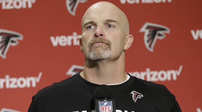 Atlanta Falcons head coach Dan Quinn talks to reporters in a post-game press conference following an NFL football game against the Seattle Seahawks, Sunday, Oct. 16, 2016, in Seattle. (AP Photo/Stephen Brashear)