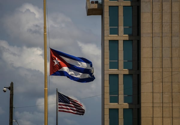 FILE - A Cuban flag is seen next to an American flag outside the U.S. embassy in Havana, Cuba, May 17, 2022. (AP Photo/Ramon Espinosa, File)