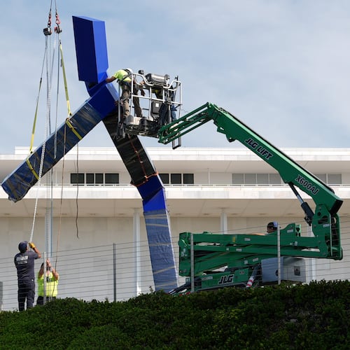 Workers remove the sculpture "Blue" by artist Joel Shapiro on the grounds of the John F. Kennedy Center for the Performing Arts in Washington, Wednesday, Sept. 2, 2026. (AP Photo/Mark Schiefelbein)