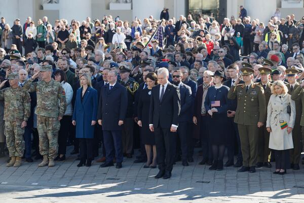 Lithuania's President Gitanas Nauseda, front center, U.S. Ambassador to Lithuania Kara C. McDonald, third left, and Speaker of Lithuanian Parliament Saulius Skvernelis, fourth left, attend a solemn farewell ceremony at Cathedral Square in Vilnius, Lithuania, Thursday, April 3, 2025 for the US soldiers who died during training exercise. (AP Photo/Mindaugas Kulbis)