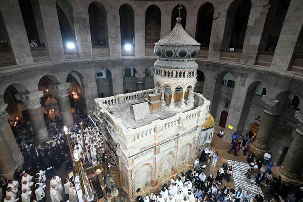 Clergy and worshippers take part in a Mass led by Latin Patriarch Pierbattista Pizzaballa, the top Catholic clergyman in the Holy Land, in remembrance of Pope Francis at the Church of the Holy Sepulcher, the site where according to tradition Jesus was crucified and buried, in the Old City of Jerusalem, Wednesday, April 23, 2025. (AP Photo/Mahmoud Illean)