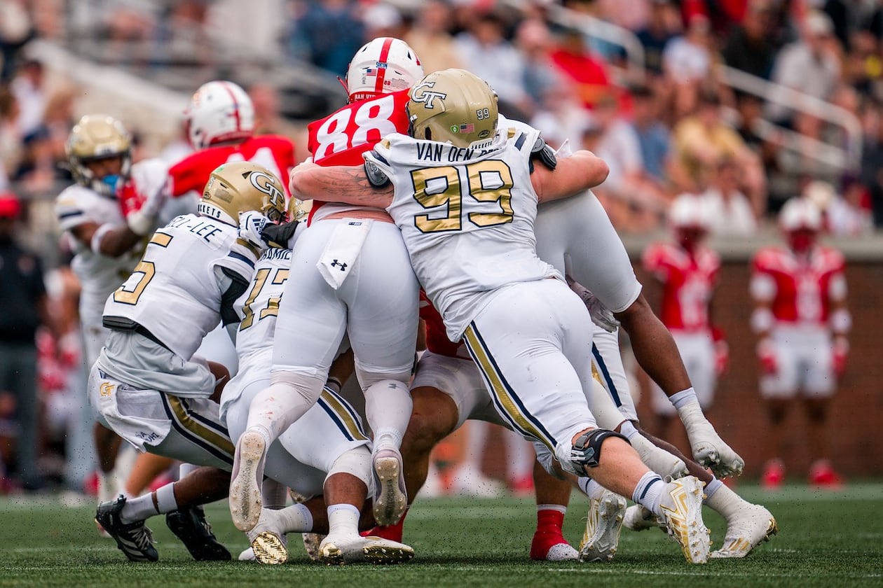 Georgia Tech defensive lineman Jordan van den Berg (right) — pictured assisted on a tackle against VMI in 2024 — had 44 tackles, including 11 for a loss, and three sacks for the Yellow Jackets last season. (Danny Karnik/Georgia Tech Athletics)