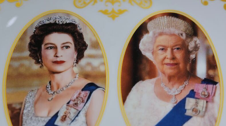 A plate with photos of late Queen Elizabeth II is on display for sale at a souvenirs shop in London, on April 17, 2026. (AP Photo/Kin Cheung)