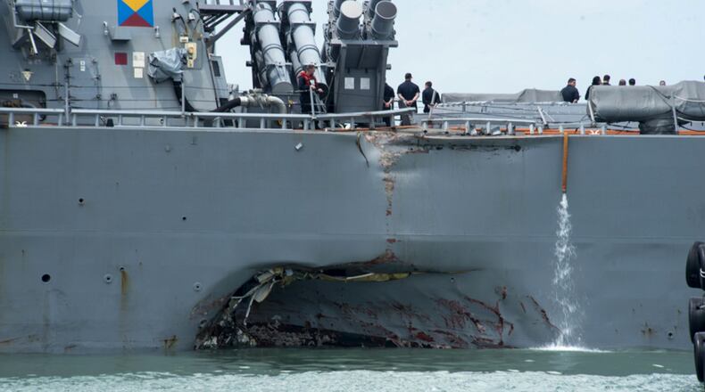 Damage to the portside is visible as the Guided-missile destroyer USS John S. McCain (DDG 56) steers towards Changi naval base in Singapore following a collision with the merchant vessel Alnic MC Monday, Aug. 21, 2017. The USS John S. McCain was docked at Singapore's naval base with "significant damage" to its hull after an early morning collision with the Alnic MC as vessels from several nations searched Monday for missing U.S. sailors. (Mass Communication Specialist 2nd Class Joshua Fulton/U.S. Navy photo via AP)