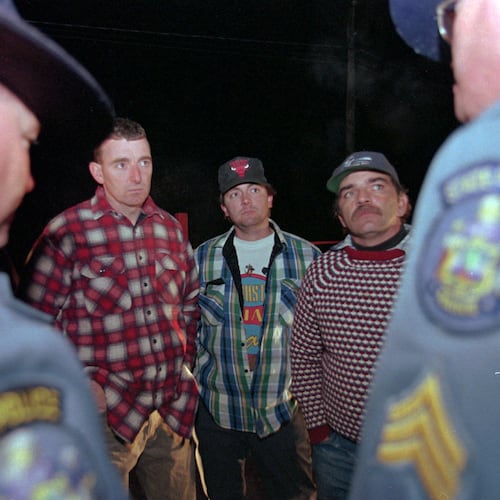 FILE - Maine loggers Stacey Kelly, second from left, Troy Jackson, and Hilton Hafford are threatened with arrest by Maine State Police if they continue to block access to Canadian woodsmen at the border at St. Pamphile, Quebec, Monday, Oct. 26, 1998. (AP Photo/Robert F. Bukaty,File)