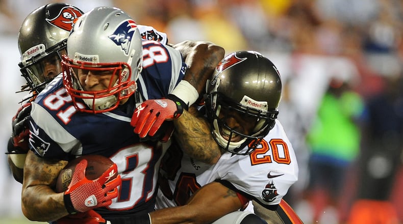 Defensive back Ronde Barber #20 of the Tampa Bay Buccaneers #20 tackles tight end Aaron Hernendez #81 of the New England Patriots at Raymond James Stadium in a pre-season game August 24, 2012 in Tampa, Florida. (Photo by Al Messerschmidt/Getty Images)