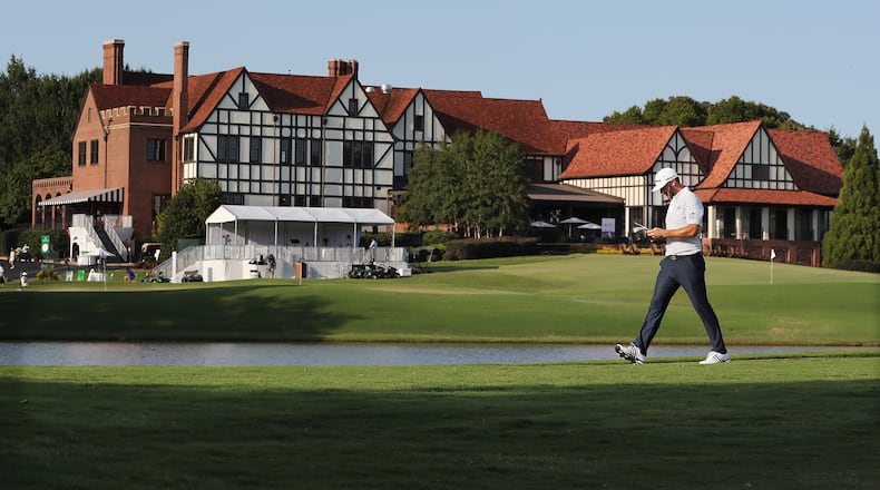Dustin Johnson walks down the 16th fairway past the clubhouse at East Lake Golf Club on Sept. 6, 2020. “Curtis Compton / Curtis.Compton@ajc.com”
