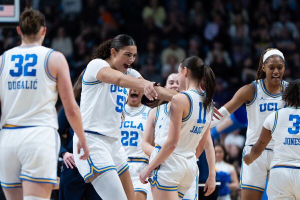 UCLA center Lauren Betts, second from left, hugs UCLA guard Gabriela Jaquez (11) during the second half of a game against LSU in the Elite Eight of the NCAA college basketball tournament, Sunday, March 30, 2025, in Spokane, Wash. (AP Photo/Jenny Kane)