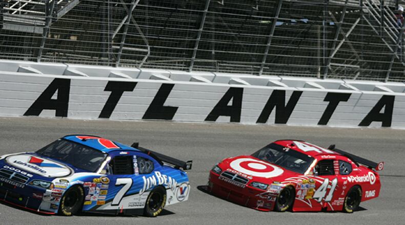 Cars fly around the track during the NASCAR Sprint Cup Series Kobalt Tools 500 at Atlanta Motor Speedway in Hampton. AMS president Ed Clark confirmed Thursday that his track will lose its March race date, leaving it with one Cup event for the first time in the track’s 50-year history.