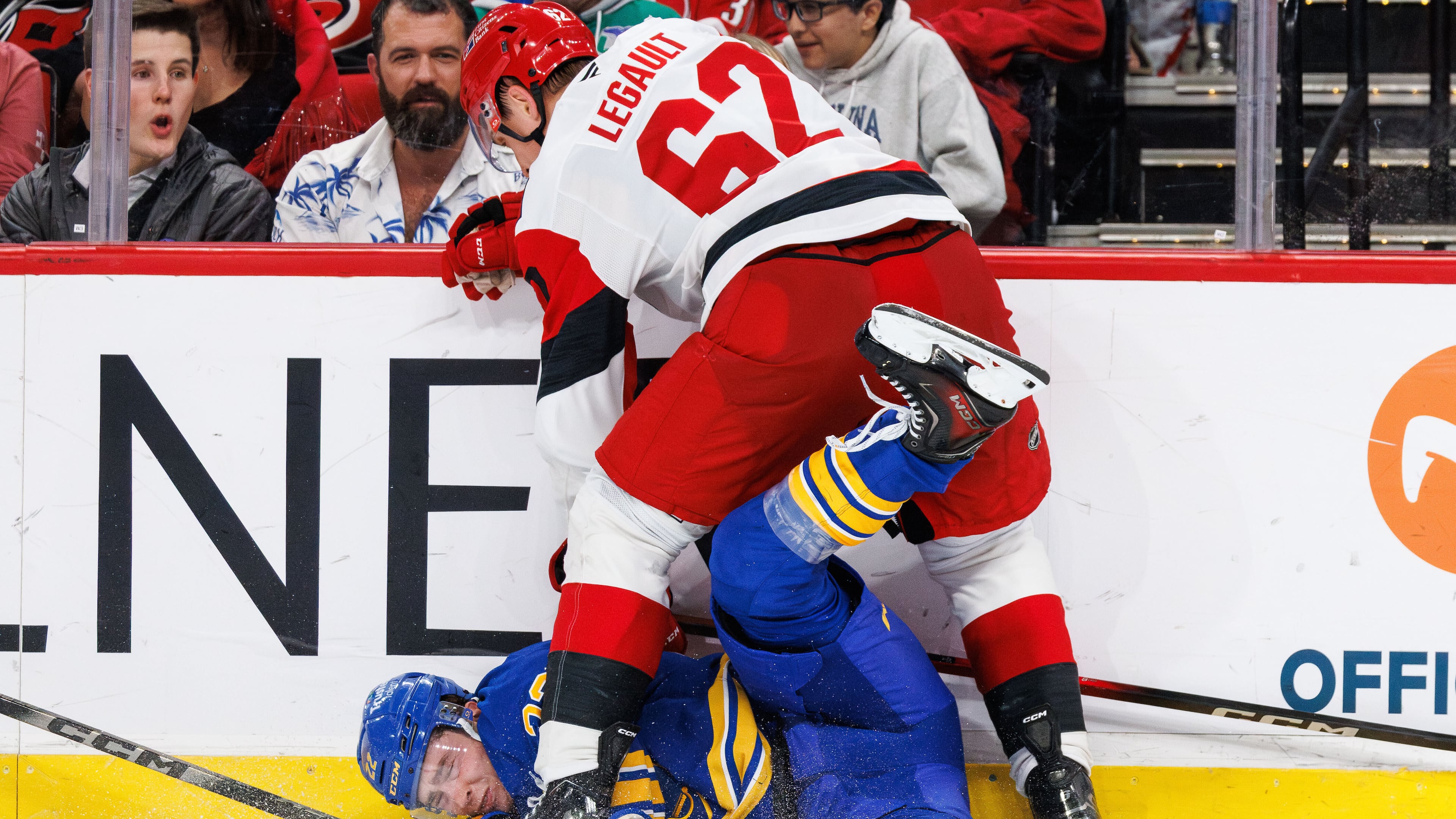 Buffalo Sabres Jack Quinn is knocked to the ice by Carolina Hurricanes Charles Alexis Legault (62) during the third period of an NHL hockey game in Raleigh, N.C., Saturday, Nov. 8, 2025. (AP Photo/Ben McKeown)