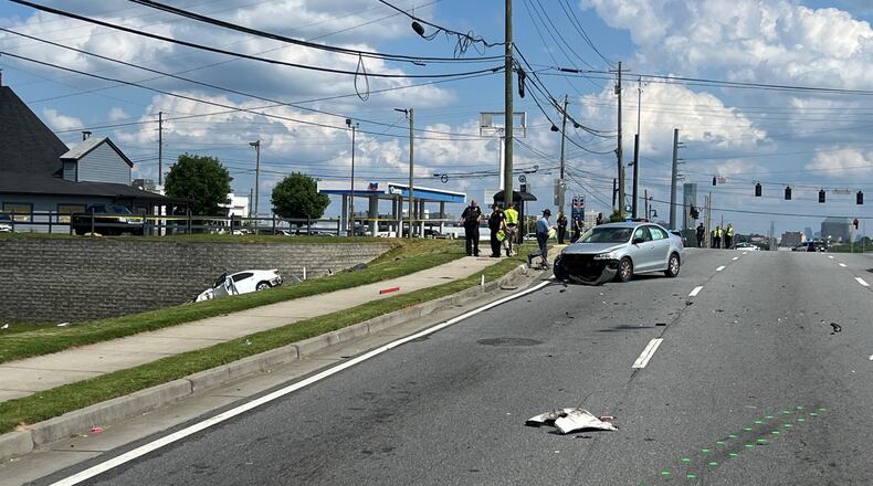 Marietta police investigated a three-car crash that left a pedestrian dead on Cobb Parkway.