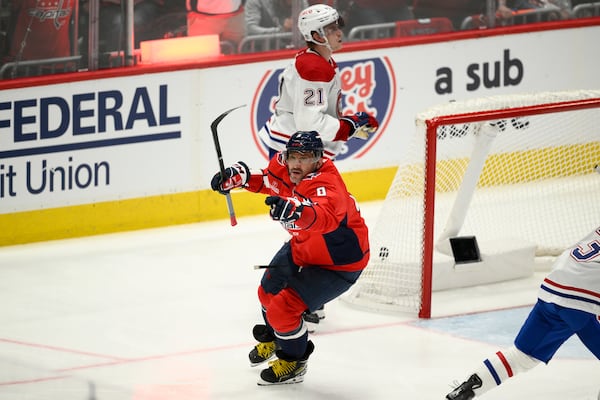 Washington Capitals left wing Alex Ovechkin (8) celebrates after his winning goal as Montreal Canadiens defenseman Kaiden Guhle (21) looks on in overtime of Game 1 of a first-round NHL hockey playoff series Monday, April 21, 2025, in Washington. (AP Photo/Nick Wass)