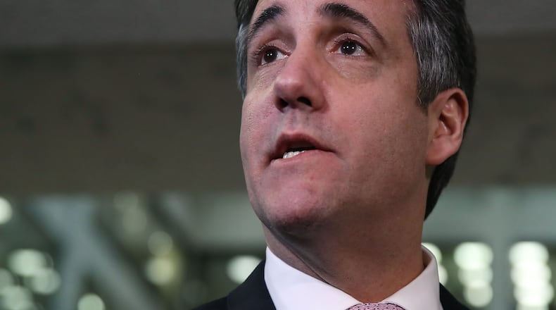 Michael Cohen, former attorney and fixer for President Donald Trump, speaks to the press at the Hart Senate Office Building after testifying to the Senate Intelligence Committee on Capitol Hill on Tuesday. Last year Cohen was sentenced to three years in prison and ordered to pay a $50,000 fine for tax evasion, making false statements to a financial institution, unlawful excessive campaign contributions and lying to Congress as part of special counsel Robert Mueller's investigation into Russian meddling in the 2016 presidential elections. Mark Wilson/Getty Images