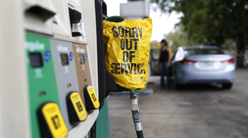 A “Sorry out of Service” sign is placed on one of the gas pumps at a gas station in Athens, Ga., on Friday, Sept. 1, 2017. Gasoline prices in the U.S. have risen to new high amid continuing fears of shortages in Texas and other states after Hurricane Harvey’s strike. (Joshua L. Jones/Athens Banner-Herald via AP)