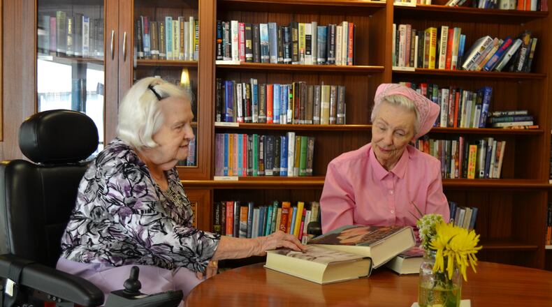 Jane Williams and Joan Lazarchik, residents at Wesley Woods Towers, in the library of the older adult community  on Clifton Road in Atlanta. Both women rely on gifts from donors to the benevolence care program of Wesley Woods to help pay for their stay at the Towers. United Methodist churches across north Georgia will collect a special Wesley Woods Sunday offering on Mother's Day