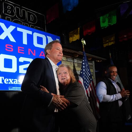Vickie Palmer, right, hugs Texas Attorney General Ken Paxton, a Republican candidate for the U.S. Senate, at a campaign event in McKinney, Texas, Tuesday, May 19, 2026. (AP Photo/LM Otero)