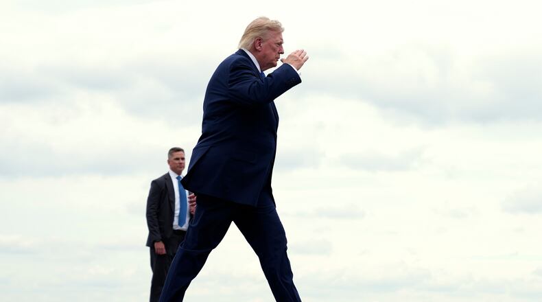 President Donald Trump walks to board Air Force One at Morristown Municipal Airport, in Morristown, N.J., Sunday, Aug. 2, 2026, en route to return to Washington. (AP Photo/Jacquelyn Martin)