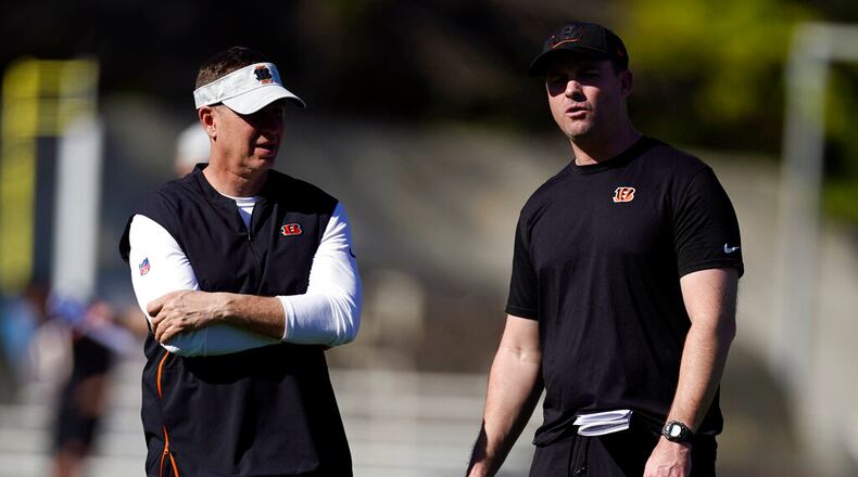 Cincinnati Bengals head coach Zac Taylor, right, talks to defensive coordinator Lou Anarumo during NFL football practice Wednesday, Feb. 9, 2022, in Los Angeles. The Cincinnati Bengals play the Los Angeles Rams in the Super Bowl Feb. 13. (AP Photo/Marcio Jose Sanchez)