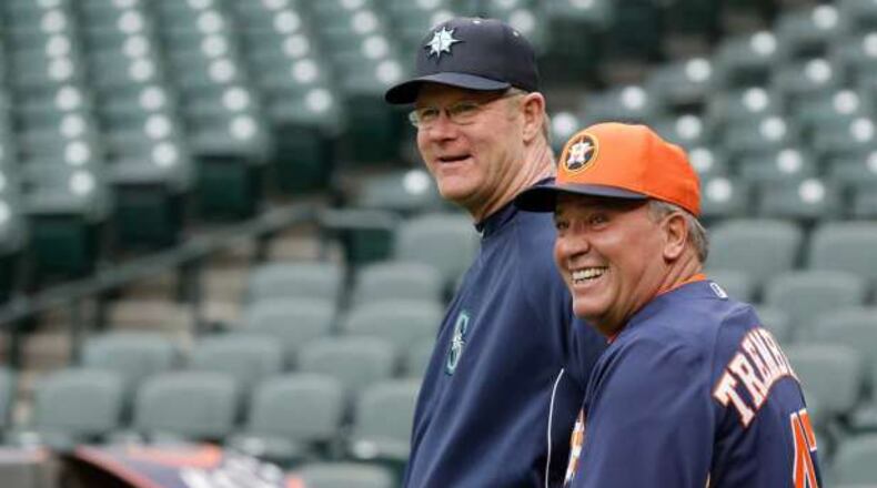 Third-base coaches Jeff Datz (left) of the Mariners and Dave Trembley of the Astros chat before a 2013 game. Datz is the Braves’ new roving catching instructor. Trembley has served as the Braves’ director of player development since October 2014.