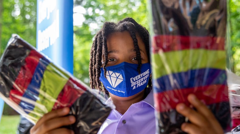 Young philanthropist, 11-year-old Malon James is at a Families First event in Norcross where he is giving away quality masks for to those in need Thursday, April 29, 2021. The non-profit organization has received grant funding and is serving underprivileged communities. (Jenni Girtman for The Atlanta Journal-Constitution)