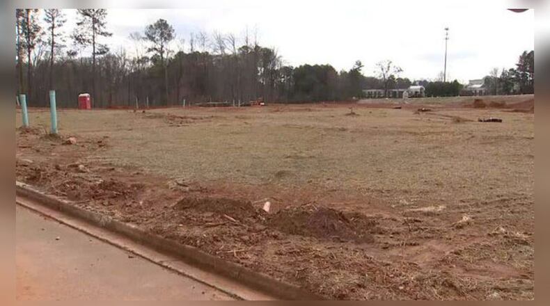 DeKalb County police are investigating a homicide after a sanitation worker found a body wrapped in plastic.