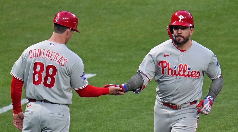Philadelphia Phillies' Kyle Schwarber, right, rounds third base to greetings from third base coach Anth Contreras (88) after hitting a two-run home run off Pittsburgh Pirates pitcher Braxton Ashcraft during the fifth inning of a baseball game in Pittsburgh, Friday, May 15, 2026. (AP Photo/Gene J. Puskar)