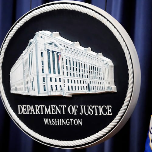 FILE - The logo for the Justice Department is seen before a news conference at the Department of Justice on Aug. 23, 2024, in Washington. (AP Photo/Mark Schiefelbein, File)
