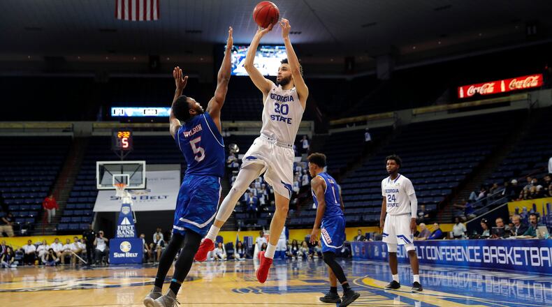 Georgia State forward Jeff Thomas (30) shoots against Texas-Arlington guard Kaelon Wilson (5) in the first half of the the Sun Belt Conference NCAA college basketball championship game in New Orleans, Sunday, March 11, 2018. (AP Photo/Gerald Herbert)