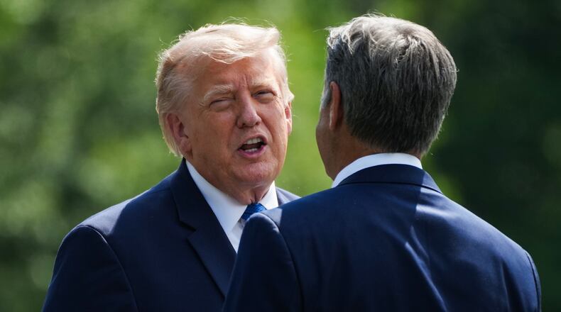 President Donald Trump, left, and CIA Director John Ratcliffe speak as they depart following a cabinet meeting at Camp David, near Thurmont, Md., Friday, July 31, 2026. (Nathan Howard/Pool Photo via AP)