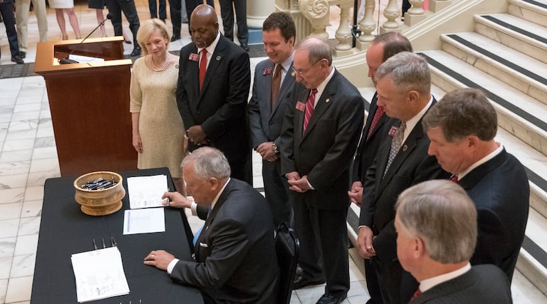 April 27, 2017, Atlanta - Governor Nathan Deal signs House Bill 338. It requires intervention in Georgia’s lowest-performing schools. (DAVID BARNES / DAVID.BARNES@AJC.COM)