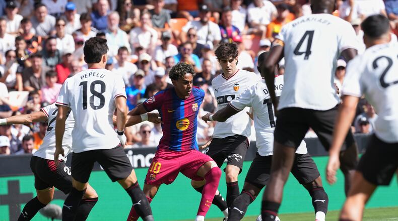 Barcelona's Lamine Yamal fights for the ball during a Spanish La Liga soccer match between Valencia and Barcelona in Valencia, Spain, Sunday, Sept. 6, 2026. (AP Photo/Alberto Saiz)