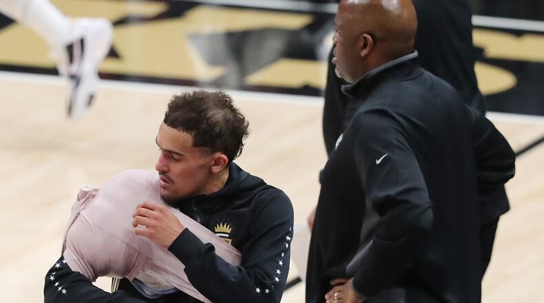 Hawks guard Trae Young comes back in the game during the 4th quarter with his arm and shoulder iced down against the Philadelphia 76ers in game 4 of their NBA Eastern Conference semifinals series on Monday, Jun 14, 2021, in Atlanta.