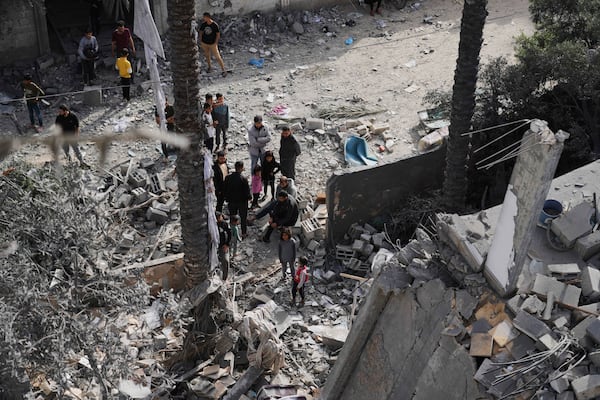 Palestinians inspect the site hit by an Israeli strike in Deir al-Balah, Gaza Strip on Monday, April 7, 2025. (AP Photo/Abdel Kareem Hana)