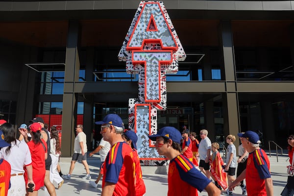Soccer fans walk past The CTR ATL on their way to Atlanta Stadium (Mercedes-Benz Stadium) for the match between Spain and Cape Verde in the 2026 FIFA World Cup in Atlanta on June 15, 2026. It’s the first of eight World Cup matches to take place in Atlanta. (Arvin Temkar/AJC)