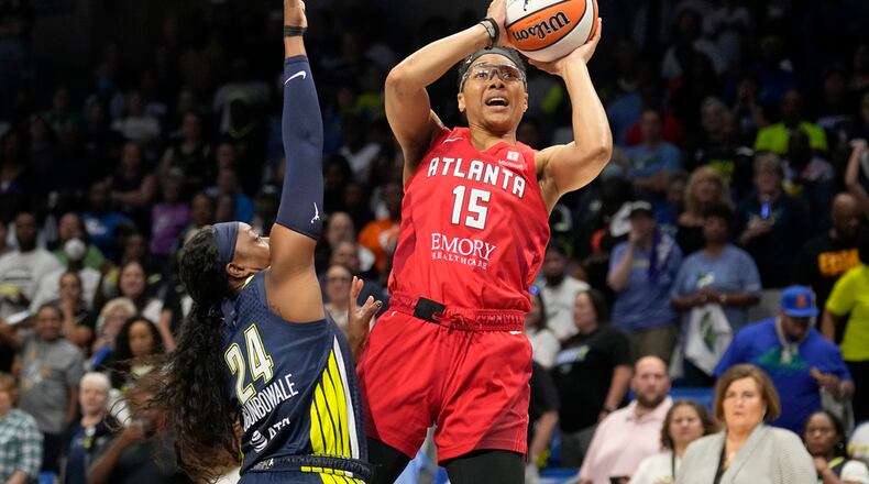 Atlanta Dream guard Allisha Gray (15) shoots as Dallas Wings guard Arike Ogunbowale (24) defends during the first half of Game 2 of a first-round WNBA basketball playoff series Tuesday, Sept. 19, 2023, in Arlington, Texas. (AP Photo/Tony Gutierrez)