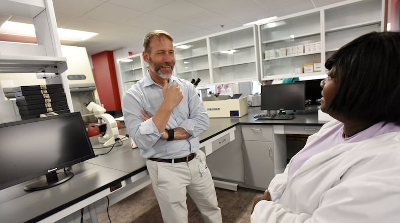 David Holland (left), Chief Clinical Officer, talks to Cassandra Marquette, Lab Director, in laboratory at new Fulton County Public Health Clinic on Tuesday, May 9, 2017. The newest Fulton County Health Center and district offices recently opened for patient and client services. Fulton County’s former flagship Aldredge Clinic is now operating as Fulton County Public Health at 10 Park Place South SE. HYOSUB SHIN / HSHIN@AJC.COM