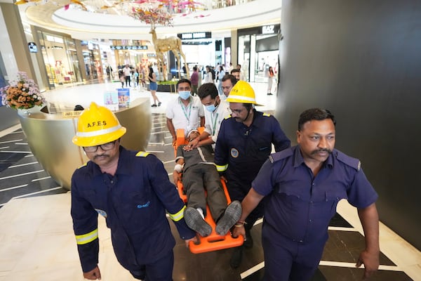 Fire brigade workers and paramedics participate in a security mock drill at a mall in Ahmedabad, India, Wednesday, May 7, 2025, amid rising fears of wider conflict following India's strikes in Pakistan. (AP Photo/Ajit Solanki)