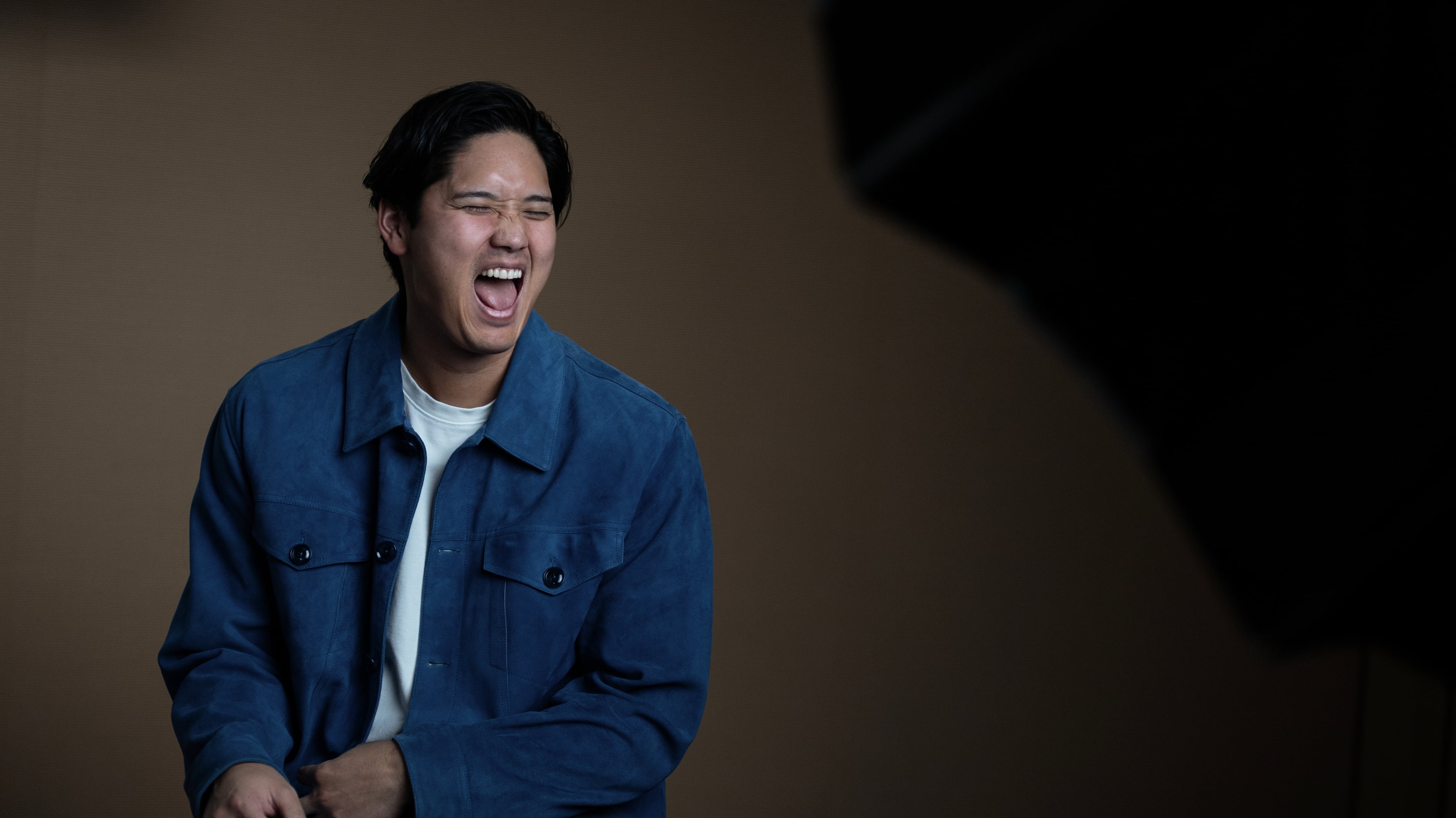 Los Angeles Dodgers' Shohei Ohtani shares a laugh with his translator during an interview with The Associated Press in Pasadena, Calif., Wednesday, Nov. 26, 2025. (AP Photo/Jae C. Hong)