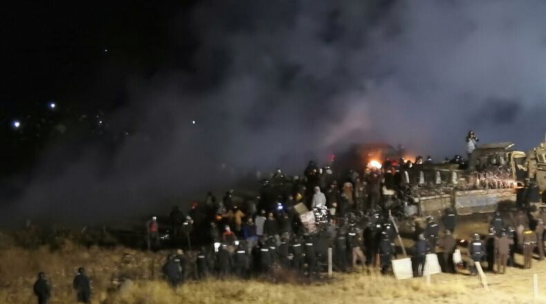 In this November 2016, file photo, provided by Morton County Sheriff's Department, law enforcement and protesters clash near the site of the Dakota Access pipeline near Cannon Ball, N.D. (Morton County Sheriff's Department via AP)