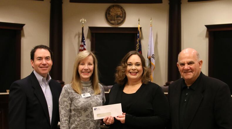 Sugar Hill officials accepting checks from the Georgia Municipal Association Safety and Liability Management Grant program. (Courtesy City of Sugar Hill)