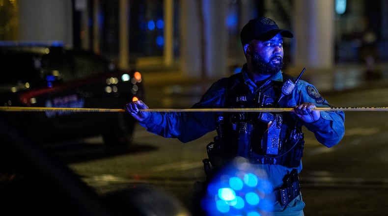An Atlanta police officer secures the scene after a shooting at the 17th Street bridge near Atlantic Station on Nov. 26, 2022. (Photo: Ben Hendren for The Atlanta Journal-Constitution)