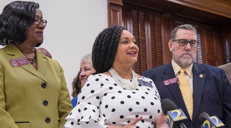 State Sen. Nikema Williams is flanked by two Democratic colleagues.  (ALYSSA POINTER/ALYSSA.POINTER@AJC.COM)