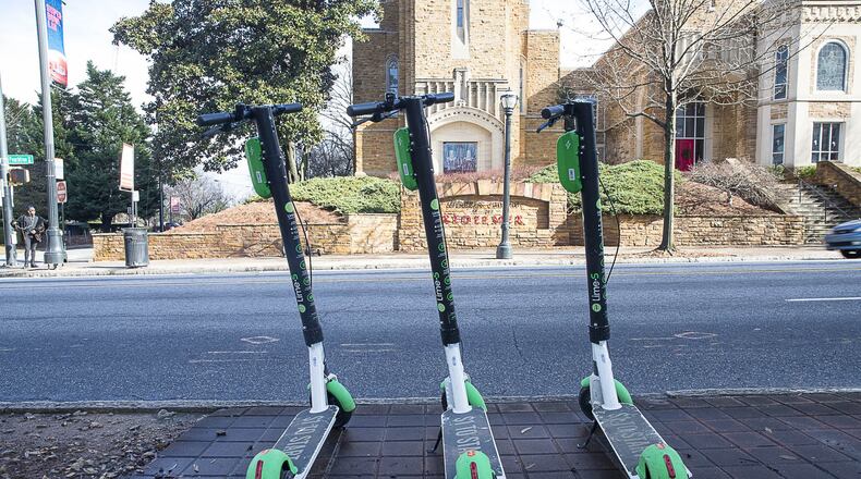 01/04/2019 — Atlanta, Georgia — Lime Scooters sit parked on the sidewalk on Peachtree Street in Atlanta’s Midtown community, Friday, January 4, 2019. (ALYSSA POINTER/ALYSSA.POINTER@AJC.COM)